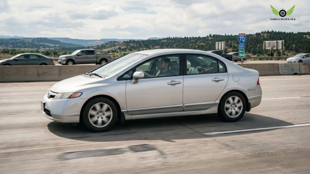 High mileage Honda Civic Sedan driving on an American highway