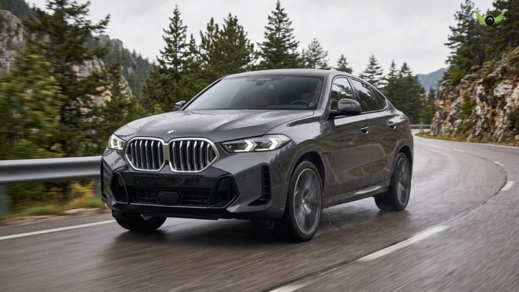 2026 BMW X6 driving on a wet road demonstrating xDrive all-wheel drive