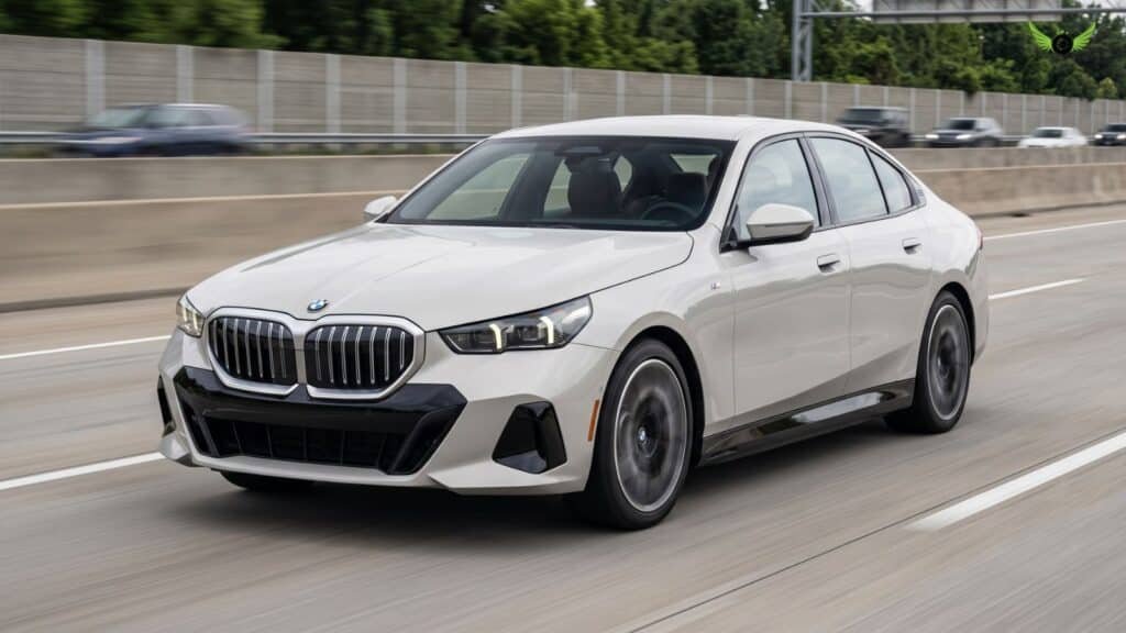 2026 BMW 5 Series driving on an American highwa