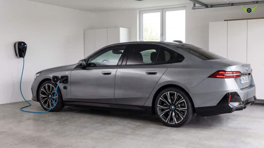 2026 BMW 550e xDrive plug-in hybrid charging at a Level 2 charger