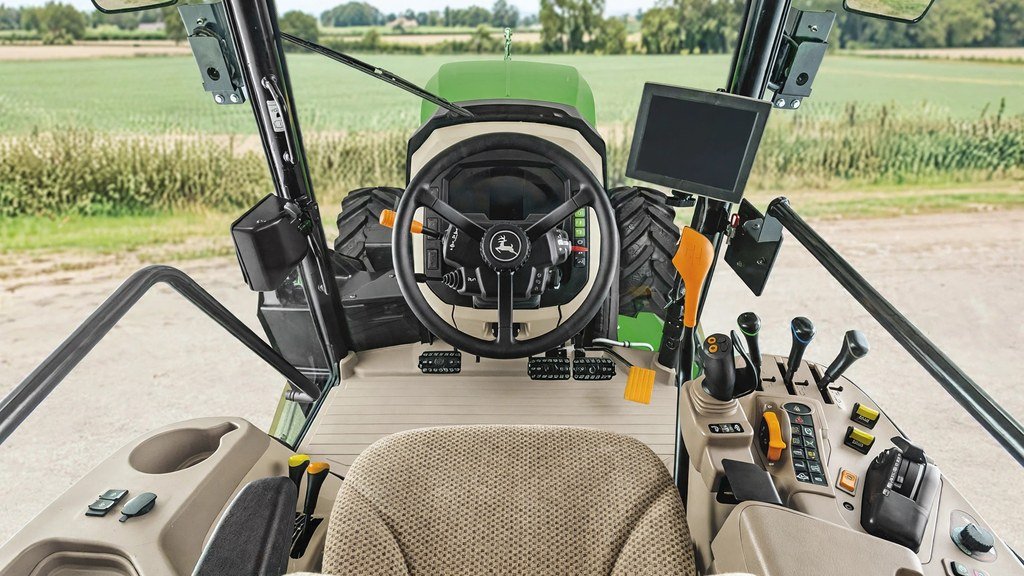 Interior of a John Deere 5M series tractor cab showing operator controls