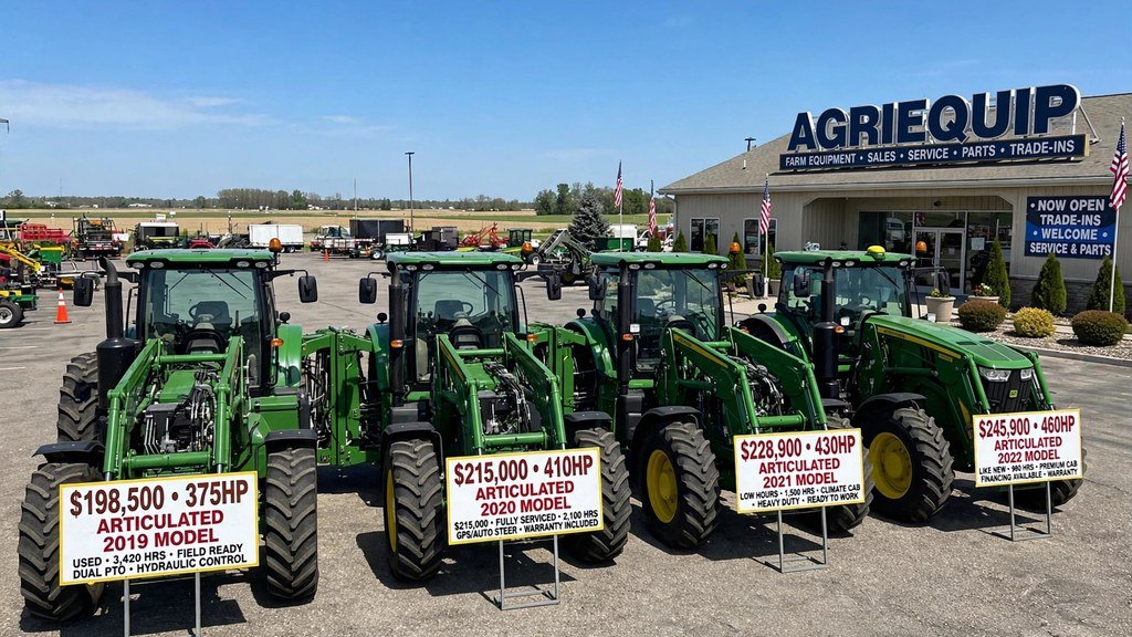 Used John Deere 9R Series tractors lined up on a dealership lot