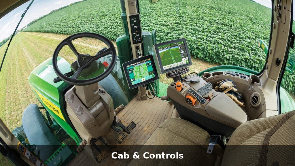 Inside the cab of a John Deere tractor showing controls and digital displays