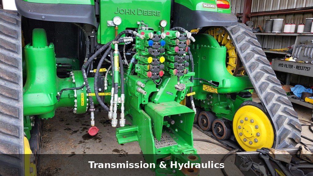 Rear hydraulic remotes, hoses and drawbar area of a John Deere 9520RX four-track tractor