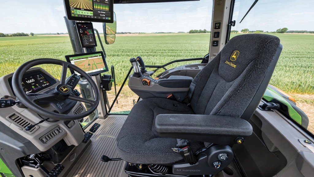 Modern John Deere tractor cab with air-suspension seat and touchscreen display - Vehicle Review Hub