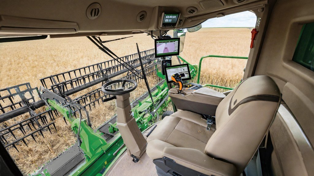 Inside the cab of a John Deere combine during harvest - Vehicle Review Hub